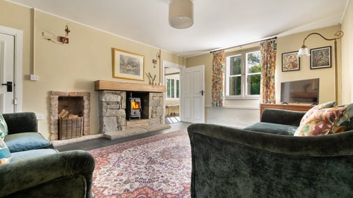 The sitting room with woodburner and television, at Castle Ward Gamekeeper's Lodge, County Down
